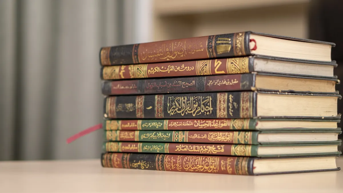 A stack of Arabic Islamic study books on a table.