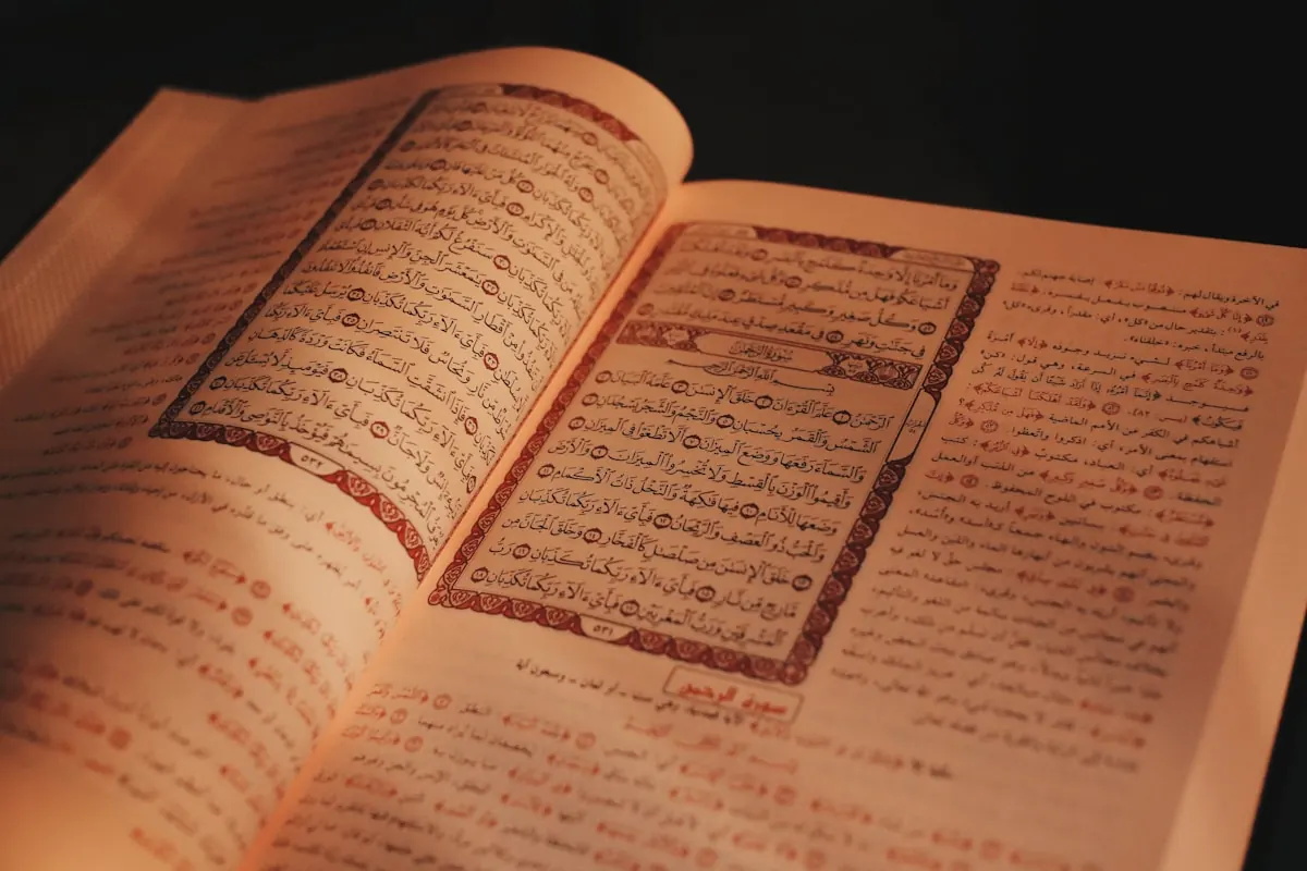 Open Quran with printed commentary beside the verses.